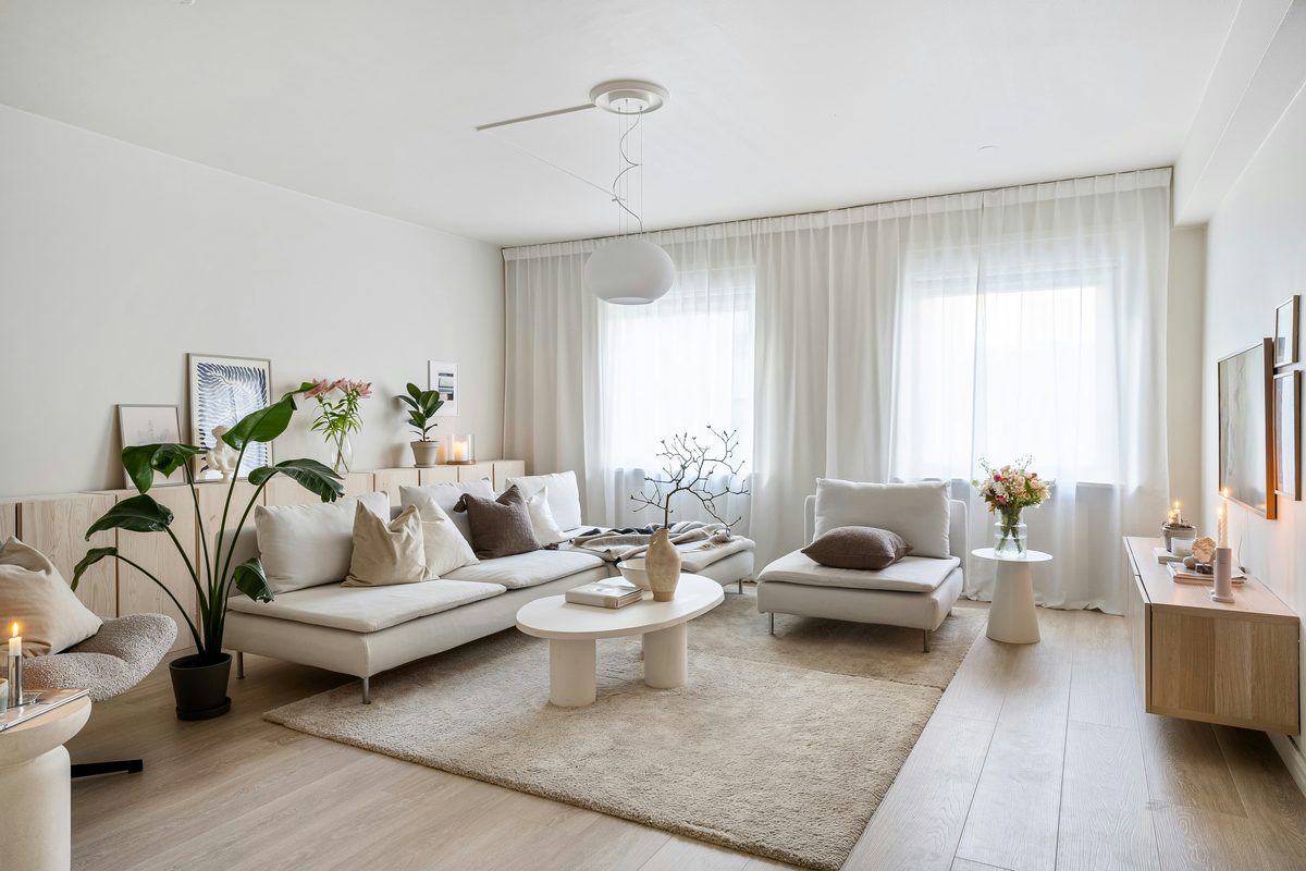 A serene Ibiza apartment interior with light wood floors, natural textures, and afternoon light.